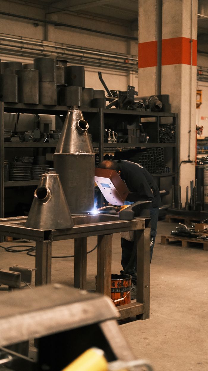 Welder working on metal structures in a Konya, Türkiye factory.
